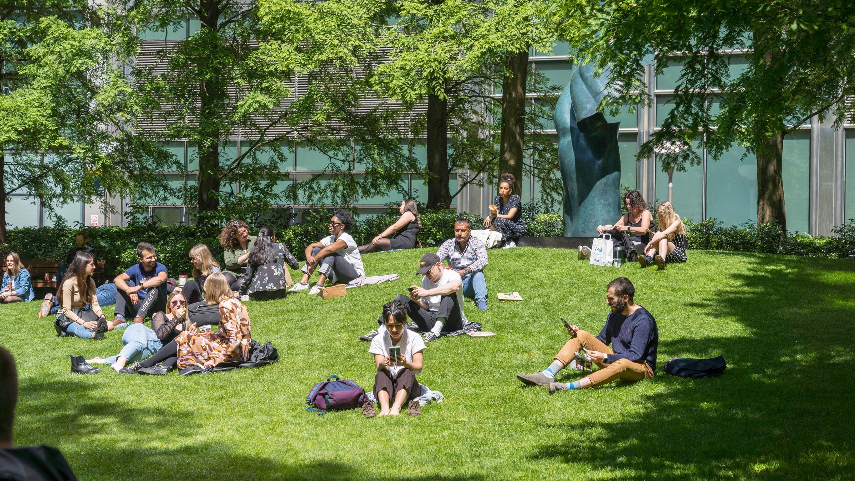 People enjoying Jubilee Park in Canary Wharf