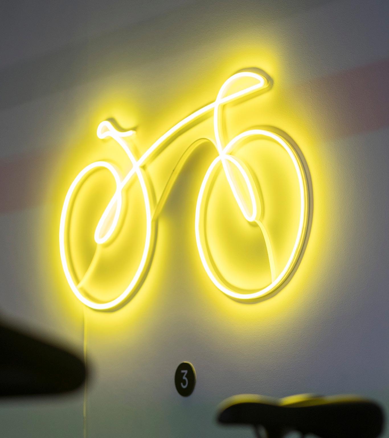 Neon wall sign for bicycle studio at 50 Bank Street